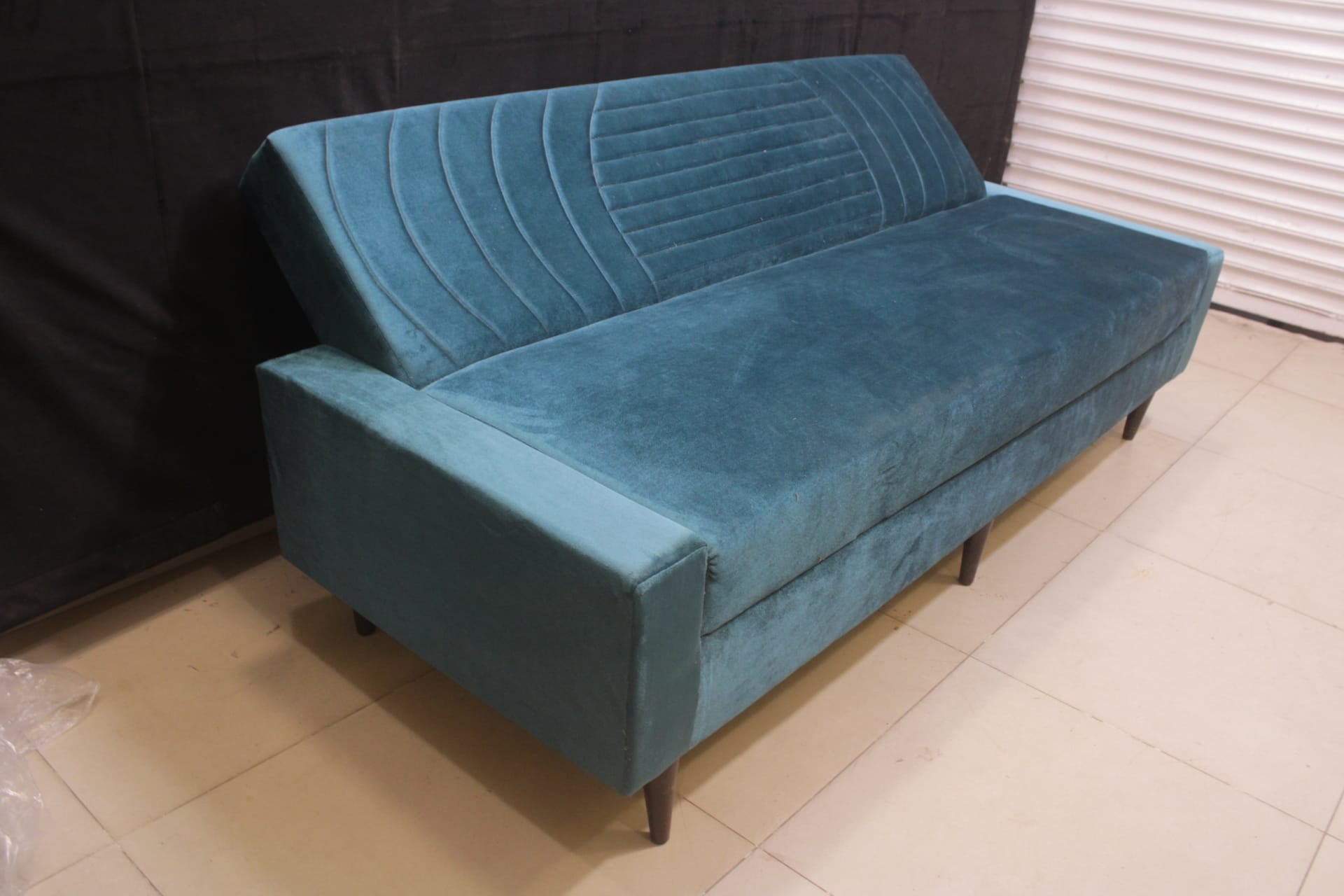 Sofa Cum Bed Upholstered in Premium Velvet Fabric With An Easy Pull-out Mechanism.