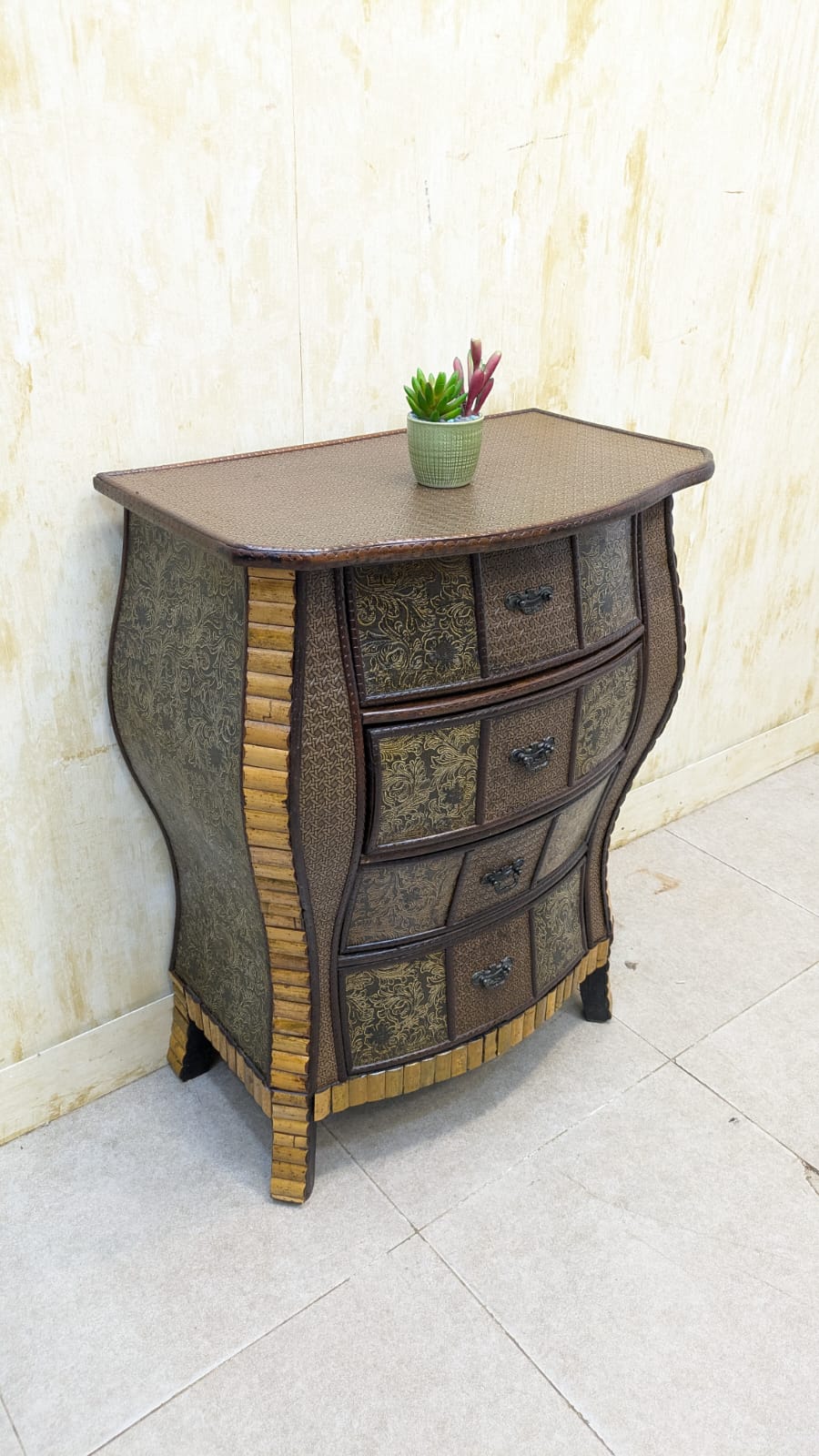 IMPORTED Antique Anglo-Indian rattan and pressed brass bombe bedside chest with four drawers.